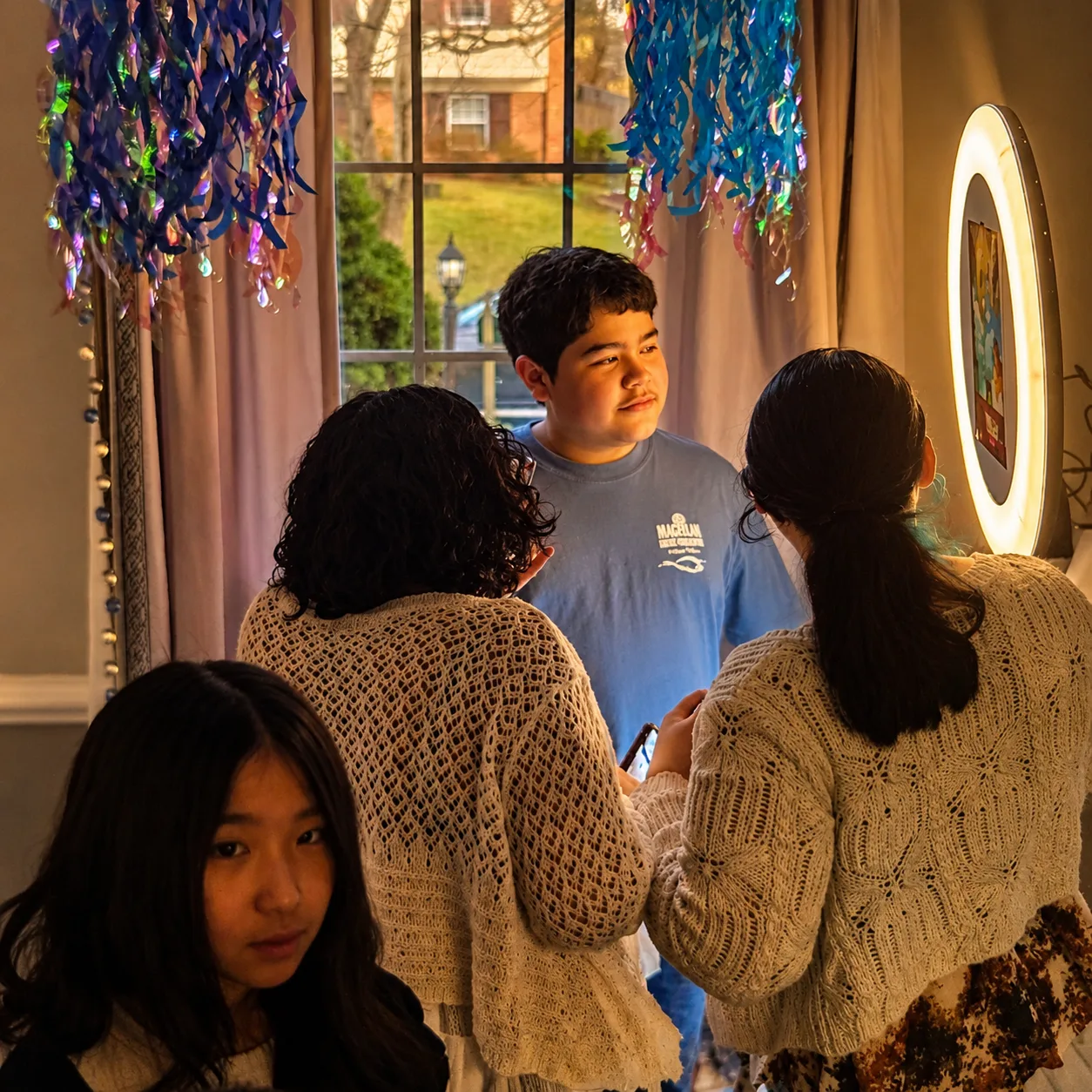 Teens caught mid-laugh at the mirror photo booth